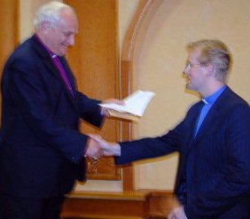 The Primate presenting Rev Michael Parker with 1st prize in the parish website competition