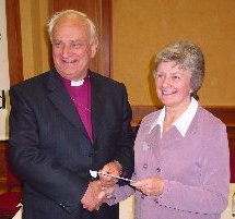 Betty McLaughlin accepting her award from the Primate